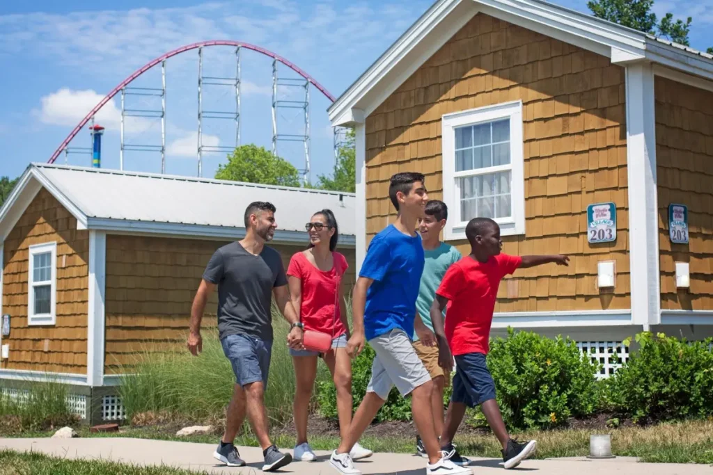 A group of guests walking past a cottage at Worlds of Fun Village